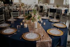 the table is set with gold and white plates