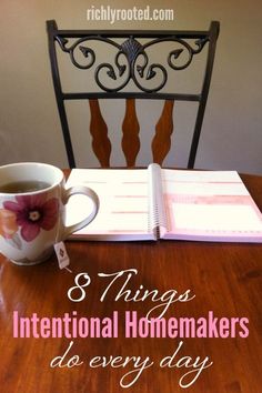 a wooden table with a coffee cup and notebook on it next to a chair that says 8 things international homemakers do every day