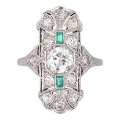 Finely detailed vintage Art Deco emerald & diamond ring (circa 1920s to 1930s) crafted in platinum.   Centre set old European cut diamond is estimated at .90 carats, accented with 12 estimated 0.05 carat old mine cut diamonds. The total diamond weight is estimated at 1.50 carats (estimated at I-J colour and VS2-SI2 clarity). Two emeralds total an estimated 0.10 carats. The emeralds are in good condition with a few nicks evident and general wear visible under a 10x loupe.    The elongated mount w Diamond Ring Platinum, Antique Cocktail Ring, 3 Stone Diamond Ring, Art Deco Emerald, Promise Rings Vintage, Emerald Ring Engagement Diamond, Emerald Wedding Rings, Emerald Diamond Ring, Right Hand Rings