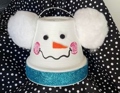 a snowman hat with ears and nose on top of polka dot fabric covered chair