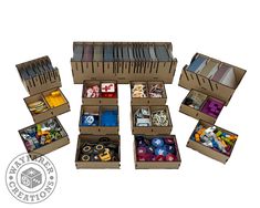 an open cardboard box filled with lots of different types of dices and boxes next to each other