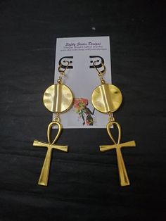 "Beautiful handmade earrings made with high quality gold plated metal Ankh symbol, with nickel free gold plated leverback earwires. Lightweight and easy to wear, these earrings are 4 1/2\" long. Please come back and visit to check for more unique new designs and styles For more styles visit my Etsy shop:www.etsy.com/shop/SoftlySisterDesigns" Handmade Symbolic Ankh Earrings, Handmade Spiritual Gold Plug Earrings, Symbolic Gold Nickel-free Earrings, Spiritual Gold Hoop Earrings In Brass, Gold Spiritual Metal Earrings, Spiritual Gold Metal Earrings, Gold Spiritual Drop Earrings, Gold Ankh Metal Jewelry, Gold Plated Symbolic Earrings