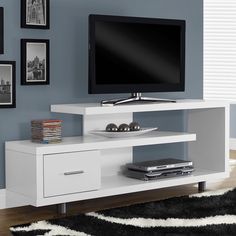 a flat screen tv sitting on top of a white entertainment center