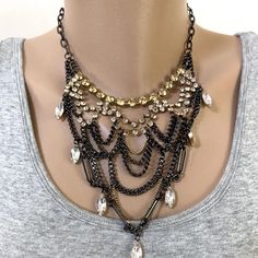 Mixed Metal Bib-Style Necklace Features Antiqued Gold Chatons, Dangling Clear Crystals And Black Gunmetal Chains. Measures 16 Inches With A Three Inch Extender And Lobster Clasp. Collection Piece That Sure To Wow When Paired With Formal Attire. Never Worn. Black Metal Rhinestone Necklace For Party, Party Black Rhinestone Metal Necklace, Elegant Black Layered Necklace For Party, Black Metal Rhinestone Necklace With Chain, Costume Jewelry Metal Layered Necklace For Party, Party Costume Jewelry Layered Necklace In Metal, Upcycling Jewelry, Diy Statement Necklace, 16 Inch Necklace