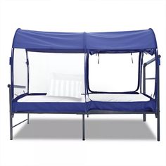 a blue canopy bed with a white pillow on the bottom and side panels over it