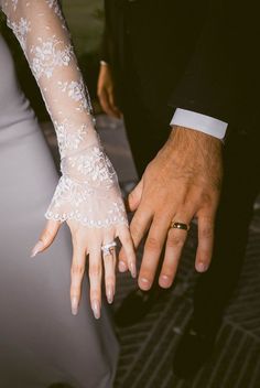 the bride and groom are holding hands together