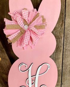 an easter bunny door hanger with the letter h on it's front and side