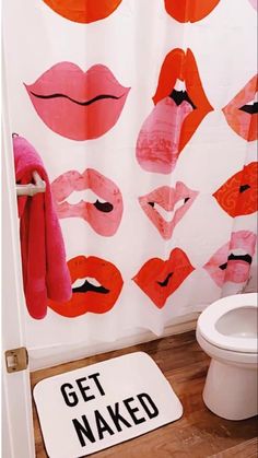 a bathroom with pink and orange lips on the shower curtain