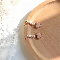 Description:Chic Pearl Heart EarringsSpecifications:Material: Eco-plated Copper, Pearl, 24k GoldSize: 3.3 cm * 1.8 cmWeight: 5 g/pair "Add a touch of elegance and love to your outfit with these Chic Pearl Heart Earrings. Perfect for any occasion, these earrings will make you stand out with their unique design. Embrace your playful side with these trendy earrings!" Heart Dangle Earrings, Trendy Earrings, Heart Earrings, Heart Design, Gifts For Women, Dangle Earrings, Great Gifts, Plating, Gold