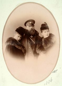 an old black and white photo of two men in fur coats, one wearing a hat