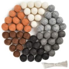 four different colors of felt balls and a tassel