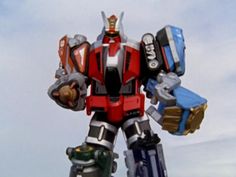 a large robot that is standing in the air with his hands on his hips and two other arms behind him