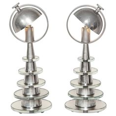 two metal lamps sitting next to each other