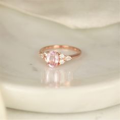 Our Thea ring here would make a great addition to any jewelry collection with her one of a kind center stone that is sure to wow the crowd! #rings #engagementrings #weddignrings #promiserings #selftreat #rosadosbox #rosegold #blush #champagne #sapphire #gemstone #diamonds #artdeco #cluster #oval #jewelry #finejewelry #gifts Oval Diamond Ring With Side Stones For Promise, Oval Diamond Promise Ring With Side Stones, Oval Rings With Side Stones For Anniversary, Oval Anniversary Rings With Side Stones, Oval Jewelry With Side Stones For Gift, Gift Oval Jewelry With Side Stones, Gift Jewelry With Oval Side Stones, Wedding Sapphire Ring With Diamond Side Stones, Classic Oval Morganite Diamond Ring