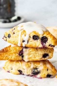 blueberry scones stacked on top of each other with icing drizzle