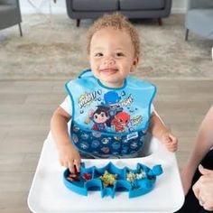 a little boy that is sitting in a high chair