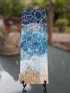 a piece of art that looks like it has been made with glass and is sitting on a table