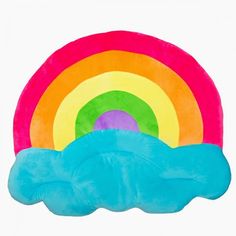 a rainbow shaped pillow sitting on top of a blue cloud in front of a white background