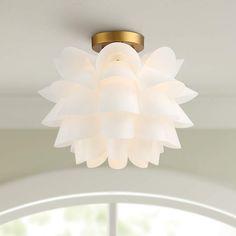 a white light fixture hanging from the ceiling