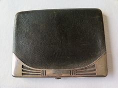 A very nice leather wallet with solid silver trim.  Brown leather with elegant solid silver applications, there is the monogram PM or MP. Inside it is lined with black silky fabric, which is a bit frayed, so it is delicate and needs attention and care in case you want to use it.  The wallet is slim but with a lot of space for banknotes and card, as you can see from the pictures.  Measures: ca. 13 x 10 cm - 5.11 x 3.93 inches Weight: 83 grams.  There is an hallmark, not easily readable, shown in Classic Compact Wallet For Formal Occasions, Classic Compact Wallets For Formal Occasions, Compact Formal Wallets With Card Slots, Silver Bifold Wallet For Formal Occasions, Classic Silver Wallet For Formal Occasions, Classic Compact Formal Wallets, Elegant Compact Wallet For Formal Occasions, Elegant Compact Wallets For Formal Occasions, Formal Compact Card Holder With Coin Pocket