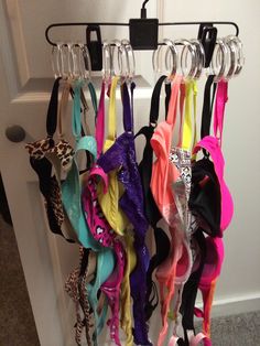 there are several pairs of bras hanging on the door hanger, all in different colors