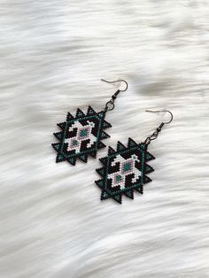 Embrace the spirit of the southwest with these stunning hand beaded eagle earrings. These earrings are meticulously crafted with love and attention to detail, featuring a majestic eagle design inspired by the rich culture and beauty of the southwest. Each bead is carefully chosen and skillfully woven to create a unique and eye-catching piece of jewelry. Whether you're a lover of Native American art, a fan of the southwest aesthetic, or simply want to make a statement with your accessories, these earrings are perfect for you.  *Features: set of two (2) nickel free fish-hook style earring with rubber backing *Hand beaded  *High quality materials *Measures approximately Let's get social! Follow us on our social media pages for behind the scenes looks, new item launch dates, and more. Facebook Southwestern Style Beaded Earrings For Gift, Southwestern Beaded Earrings As Gift, Southwestern Style Beaded Drop Earrings, Southwestern Beaded Drop Earrings For Pierced Ears, Western Seed Bead Earrings, Southwestern Style Drop Earrings, Cowgirl Earrings Western, Silver Southwestern Beaded Earrings, Beaded Eagle