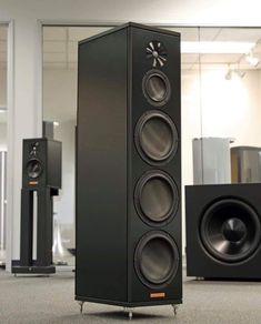 two speakers sitting on top of each other in a room