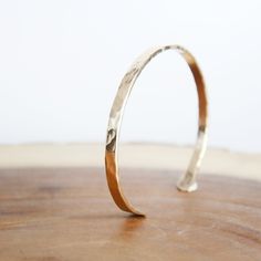 Hammered Cuff Gold-Fill Our Hammered Gold Cuff Bracelet captures the essence of the sun's radiance. As you wear the Hammered Gold Cuff Bracelet, let it be a reminder of your own luminance and strength. Much like the sun's steadfast presence, this piece accompanies you through every adventure and journey, infusing your spirit with its golden energy. 2.5mm Thick x 6" long Gold-Fill Wire (8G) Hand-Forged & hand textured Gold Filled is NOT the same as gold plated. Gold fill is much higher quality th Golden Energy, Hand Forged Jewelry, Hammered Cuff Bracelet, Gold Cuff Bracelet, Cuff Bracelets Handmade, Gold Bracelet Cuff, Hammered Gold, Gold Cuffs, Hand Stamped Jewelry