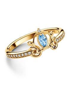 a yellow gold ring with an oval blue topazte and diamonds on the side