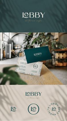 an image of some type of business cards on top of a wooden table with plants in the background