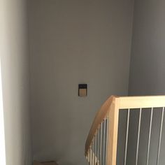 an empty room with a stair case in the corner and a box on the floor next to it