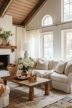 a living room filled with furniture and a fire place next to a large white couch