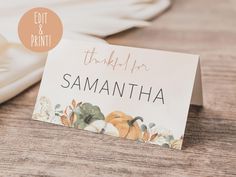 a place card sitting on top of a table next to a plate and napkins