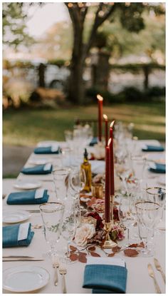 the table is set with candles and place settings