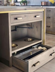 an open drawer in the middle of a kitchen