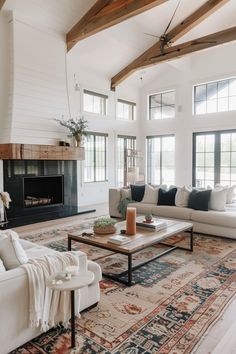 a living room filled with furniture and a fire place in the middle of an open floor plan