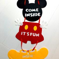 mickey mouse door hangers that say come inside, it's fun and inside