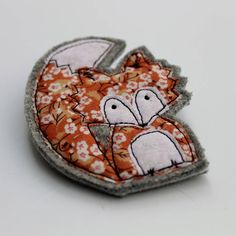 an orange and white patch with two birds on it