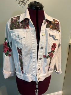 One of a kind, white denim jacket. Jacket has panels removed and replaced with sheer sequined floral patterned material. Jacket is adorned with two 3-D embroidered flower, appliqué, hand sewn. Casual White Outerwear With Patches, Fitted White Denim Jacket For Spring, White Cotton Outerwear With Floral Print, White Fitted Bohemian Outerwear, Fitted White Bohemian Outerwear, White Cotton Denim Jacket With Patchwork, White Patchwork Cotton Denim Jacket, Casual White Patchwork Denim Jacket, Casual White Embroidered Denim Jacket