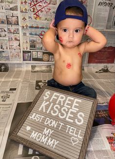 a young boy sitting on top of a newspaper with his head in his hands and the words free kisses just don't tell my mommy