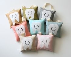 six pillows with tooth shaped faces on them