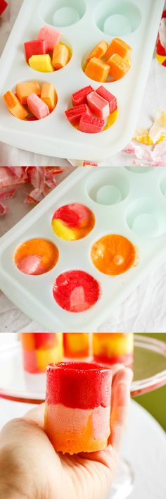 a person is holding a tray with different colored jellos in it and dipping them into ice cubes