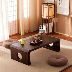 a living room with a coffee table and ottoman