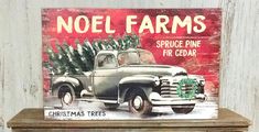 an old truck with a christmas tree on the back sits on a shelf in front of a wall