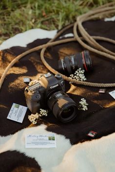 a camera sitting on top of a black and white blanket