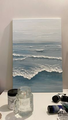 an acrylic painting of a wave coming in from the ocean on a white table