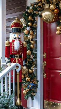 a nutcracker is standing in front of a red door and decorated for christmas