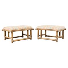 a pair of stools made out of wood and upholstered with multicolored fabric