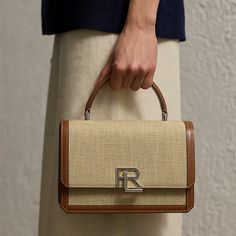 Ralph Lauren’s RL 888 collection was named in honor of our historic women’s flagship at 888 Madison Ave. in New York City where the juxtaposing worlds of Ralph Lauren convene and inspire. A strong silhouette with a spirit of independence the RL 888 Top Handle is inspired by the architecture of Mr. Lauren’s hometown. Featuring a dual-compartment interior a top handle and a removable adjustable crossbody strap accented by two polished keepers each bag is exquisitely made by hand and individually c Historic Women, Ralph Lauren Store, Ralph Lauren Handbags, Boots Shoe, Apartment Stuff, Digital Closet, Handbag Heaven, Ralph Lauren Women, Brand Bags