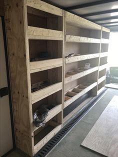 the inside of a storage room with wooden shelves